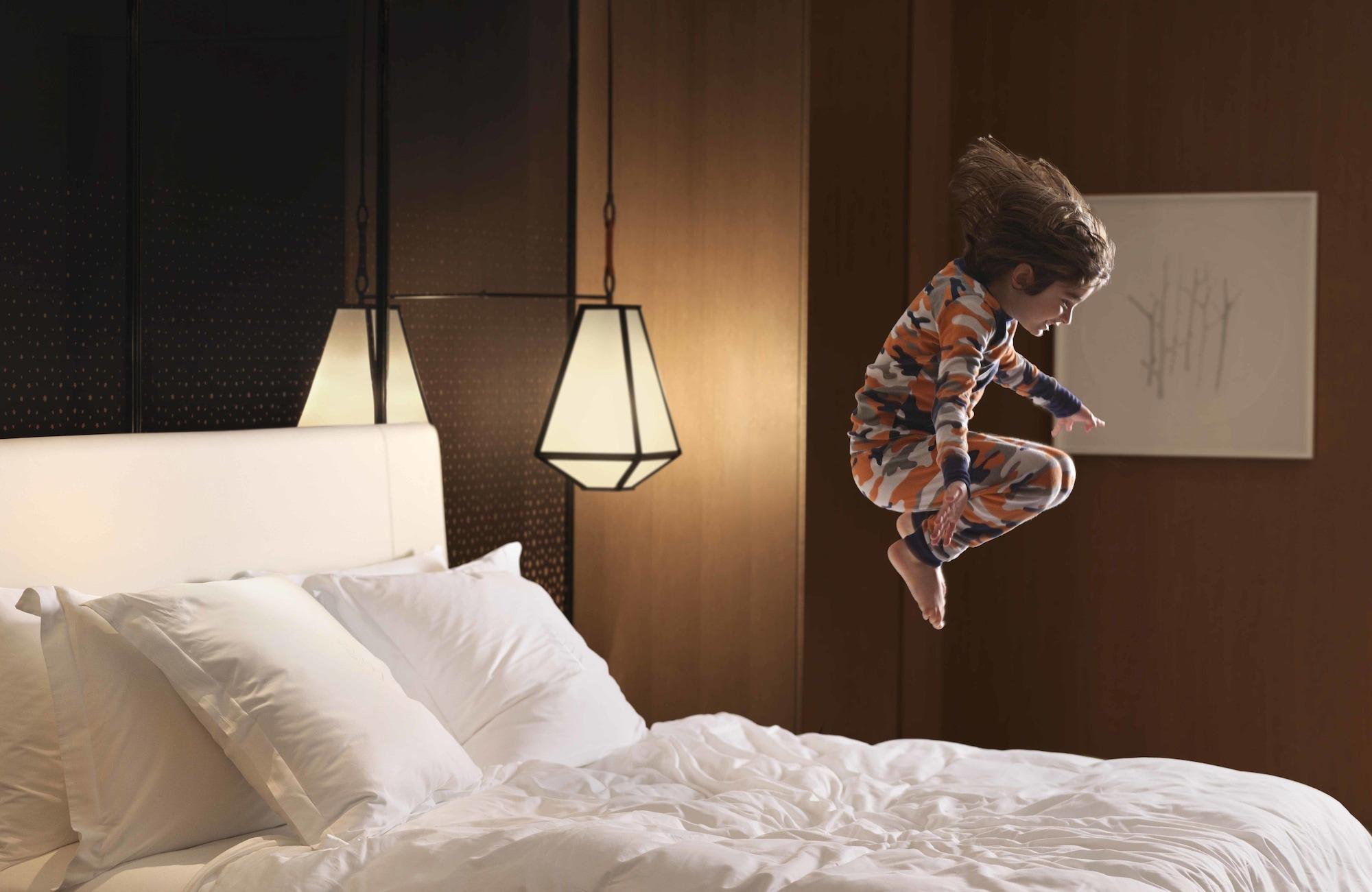 Four Seasons Hotel Kuwait At Burj Alshaya Kuwait City Exterior photo A child jumping on a bed